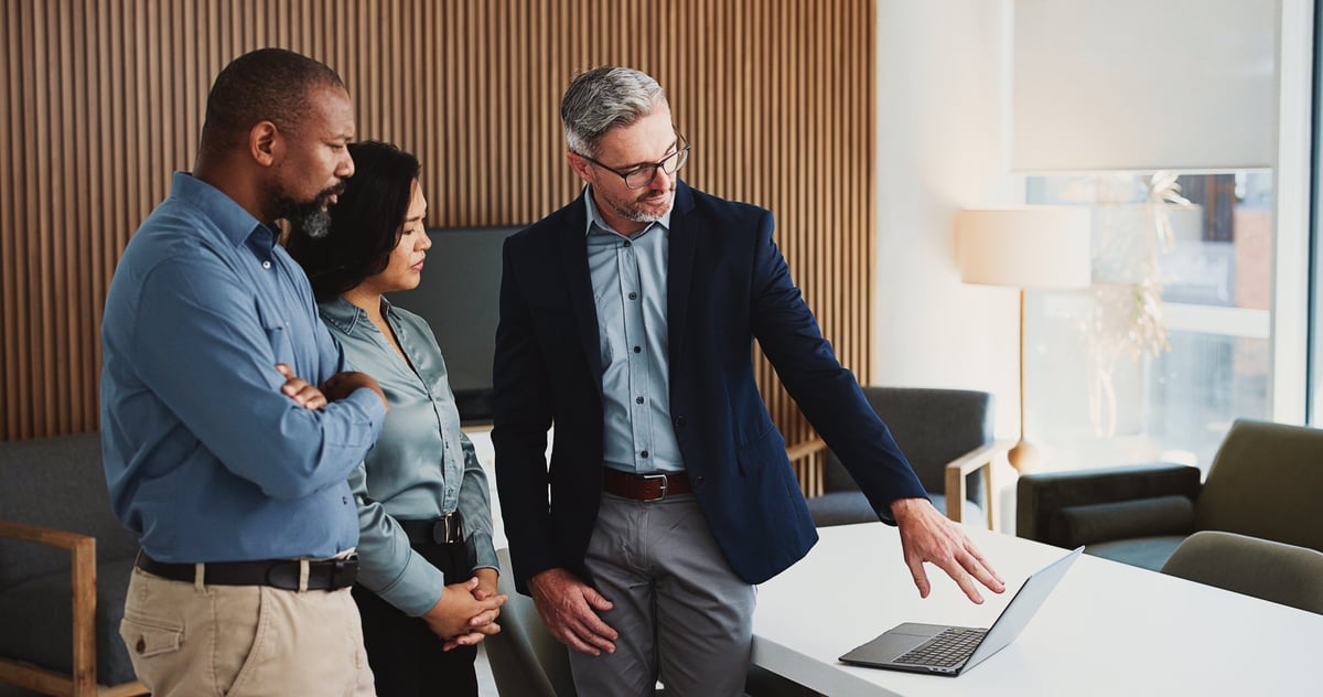 Business team collaborating on a project review in a modern office